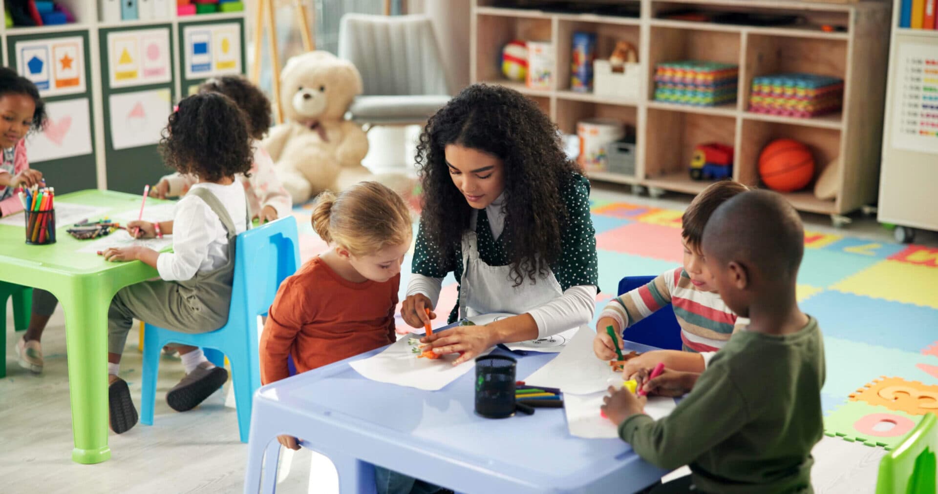 A Kids Cove teacher working with children
