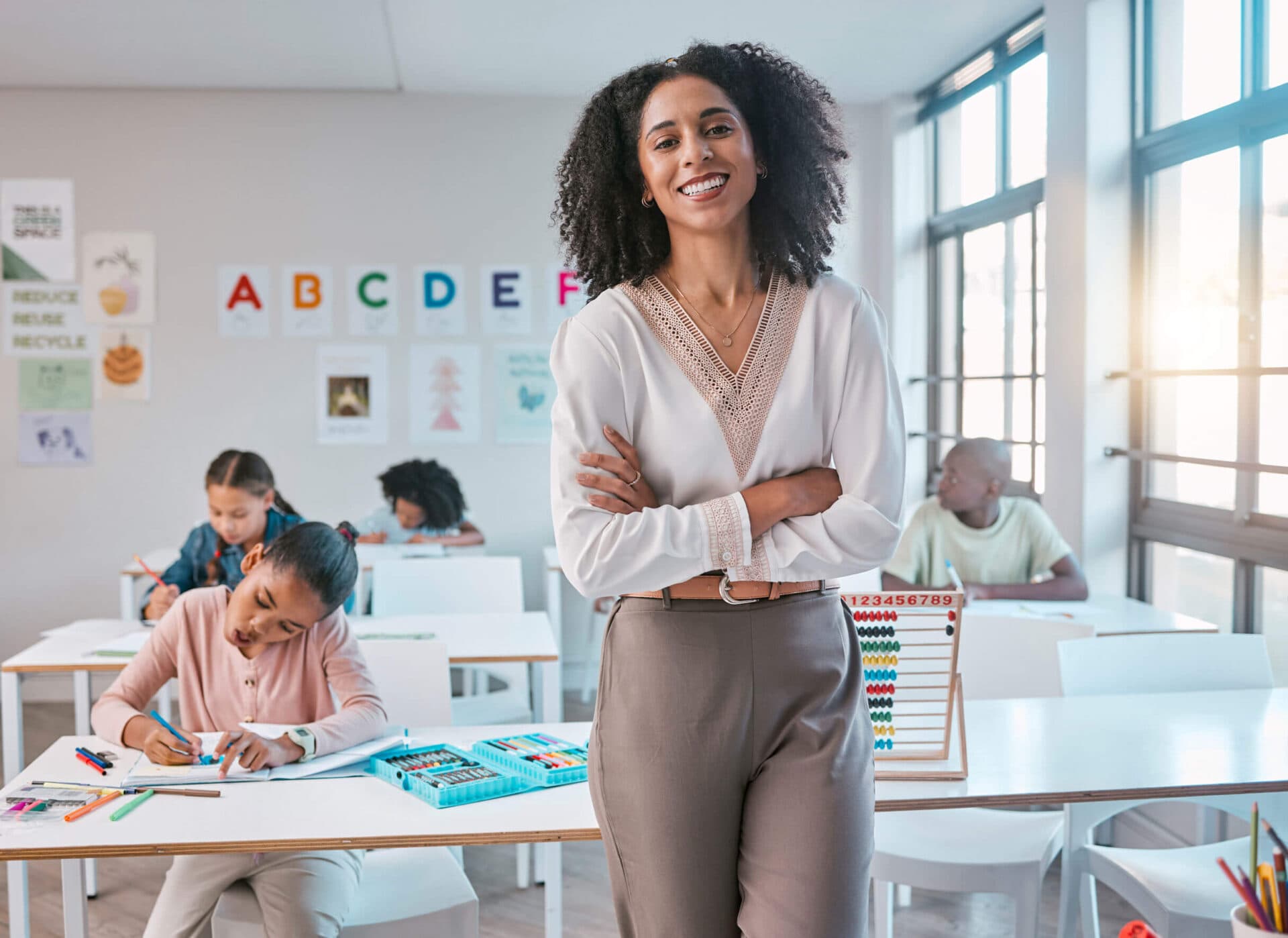 A Kids Cove teacher standing in her classroom