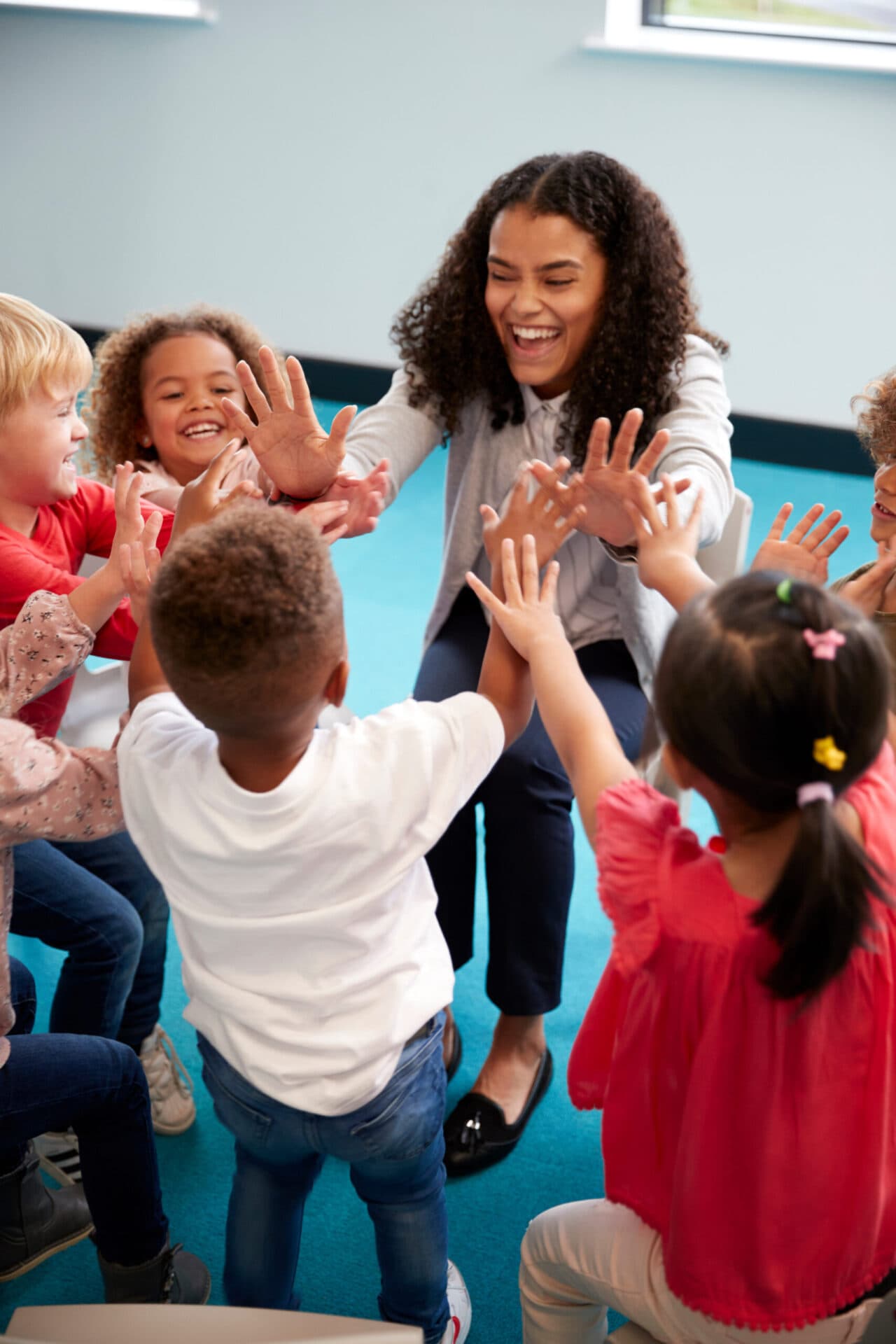 A Kids Cove teacher reading with children